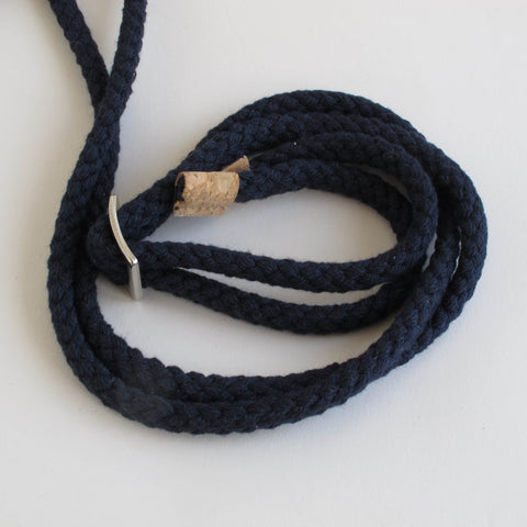 Marineblaue geflochtene Kordel zum Verstellen der Länge, mit Korkdetail und silbernem Verschluss für sicheren Halt.